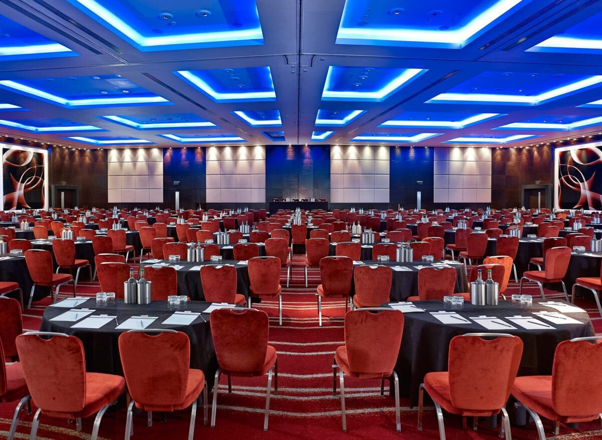 An interior hall with lots of chairs and tables set up