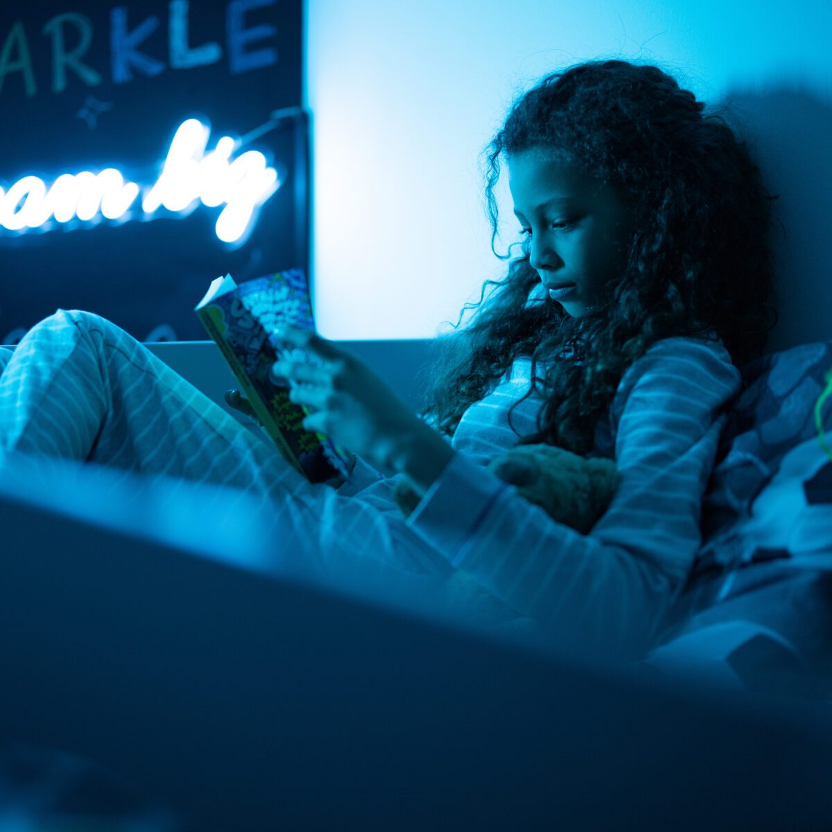 Girl reading in a family room at Park Plaza London Riverbank